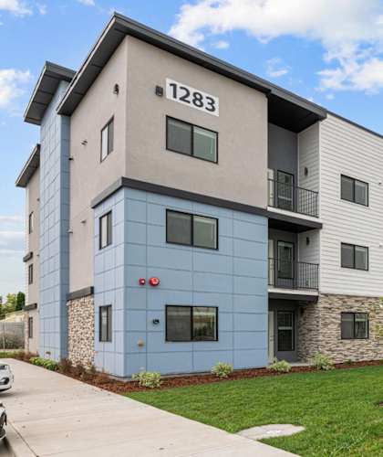 Apartment building number 1283 with a blue and beige facade.