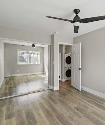a living room with white walls and wood floors at Ocean Breeze Terrace Apartment, Huntington Beach, 92648