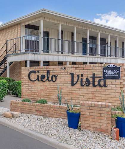 A brick building with a sign that says "Cielo Vista" in front of it.