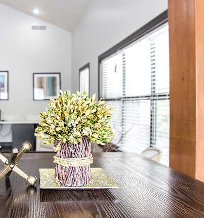 a vase of flowers on a table in an office