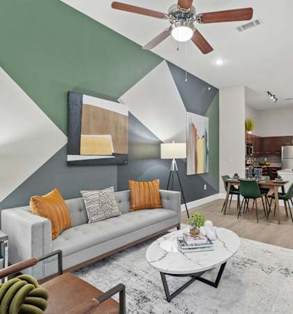 A living room with a grey couch and a coffee table.