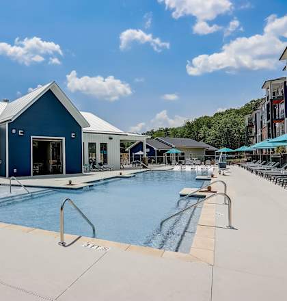 a swimming pool with a blue building in the background