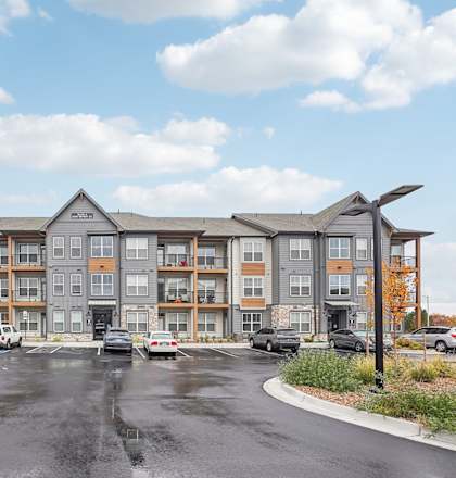 A large apartment complex with a parking lot in front. at Notch66, Longmont, Colorado