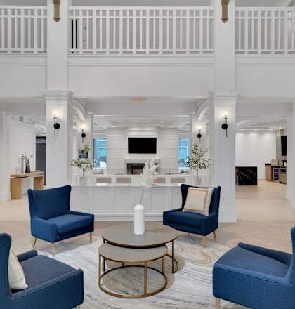 a living room with blue chairs and a coffee table