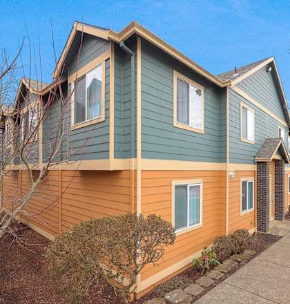 A house with a green and orange exterior is shown.