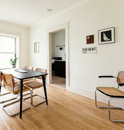 a dining room with a table and chairs and a window