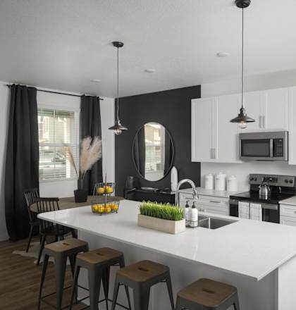 a kitchen with stainless steel appliances and a white counter top