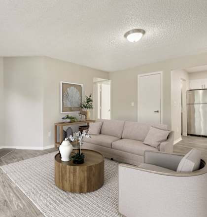 A modern living room with a fireplace and a grey sofa.