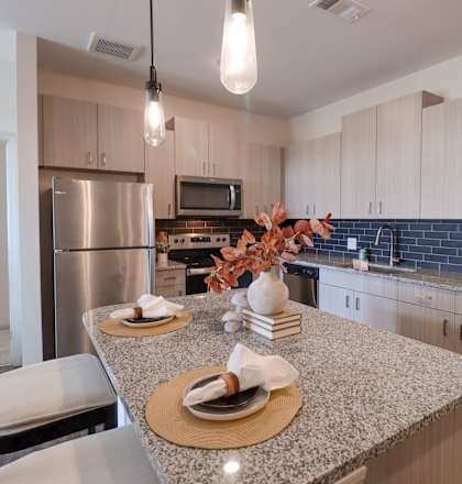 a kitchen with granite counter tops and stainless steel appliances at The Crest at Acworth, Acworth at The Crest at Acworth Apartments, Acworth, GA