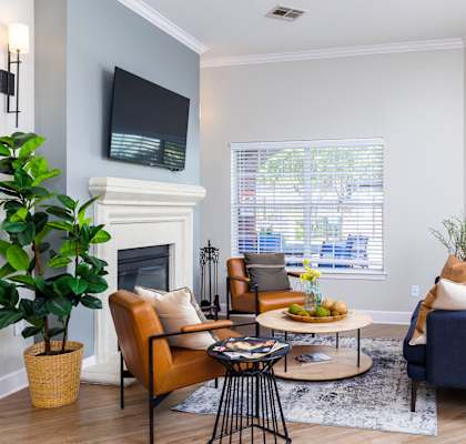 a living room with gray walls and a fireplace with a tv above it