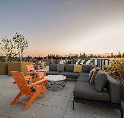 a roof deck with couches chairs and a coffee table