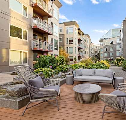 a patio with a couch and chairs on a