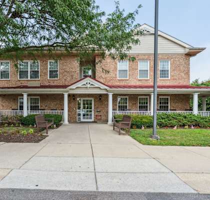 A two-story brick house with a front porch.