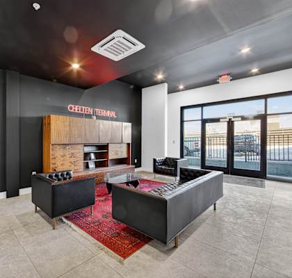 A modern office space with a reception desk and a framed sign on the wall.