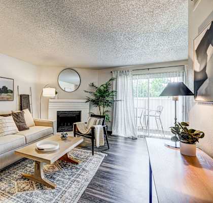 a living room with a couch and a coffee table and a fireplace