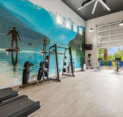 A gym with a large mural of people kayaking on a lake.