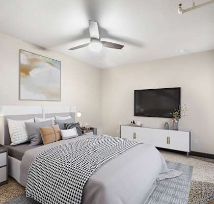a bedroom with a large bed and a ceiling fan