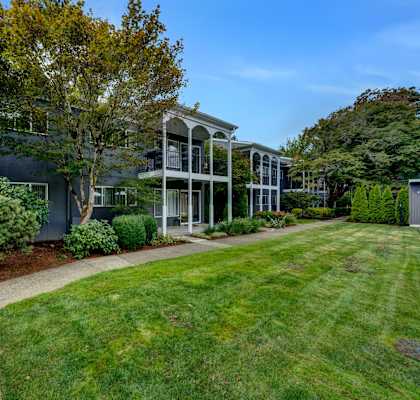 a view of a building with a grassy area in front of it