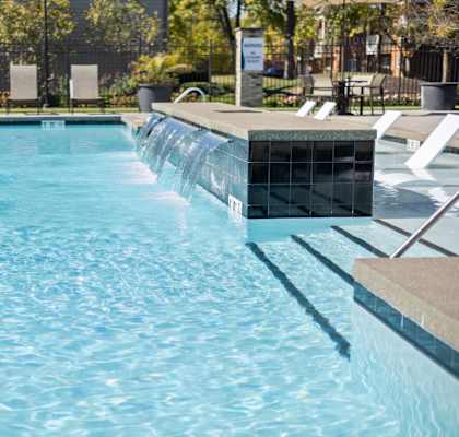 a large pool with a waterfall in the middle