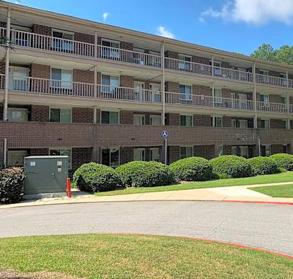 A large apartment complex with a red line painted on the road.