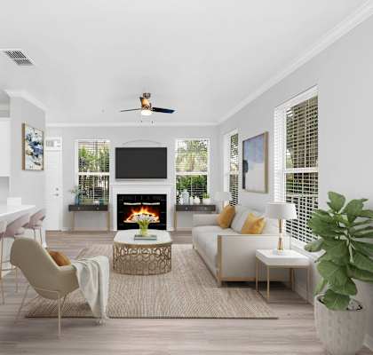 a living room with white walls and a white couch with a coffee table in front of it at Northlake Park Apartments, Florida, 32827