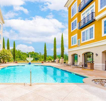A large swimming pool in front of apartment buildings at The Villagio Apartments, Fayetteville