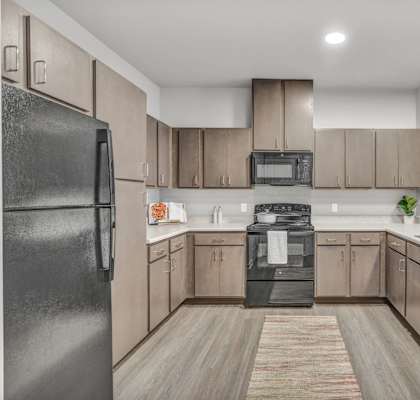 a kitchen with wooden cabinets and stainless steel appliances