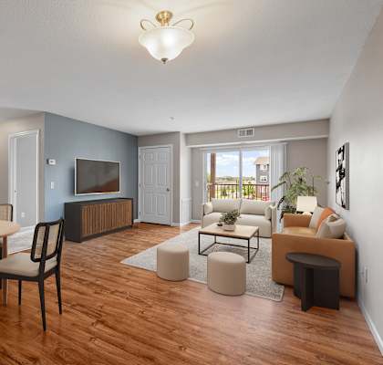 a living room and dining room with a couch and a tv