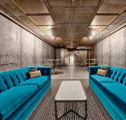a lobby with blue couches and a coffee table at Metro67, Memphis, TN