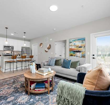 A living room with a white couch and a coffee table.