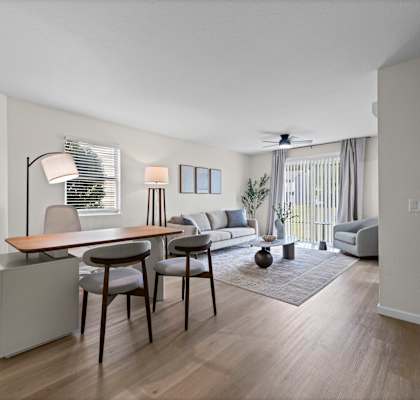 A living room with a dining table and chairs.
