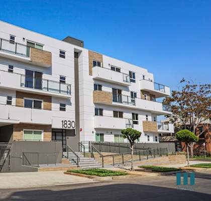 an image of an apartment building with a blue sky in the background