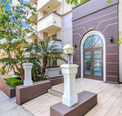 the entrance to an apartment building with a large glass door