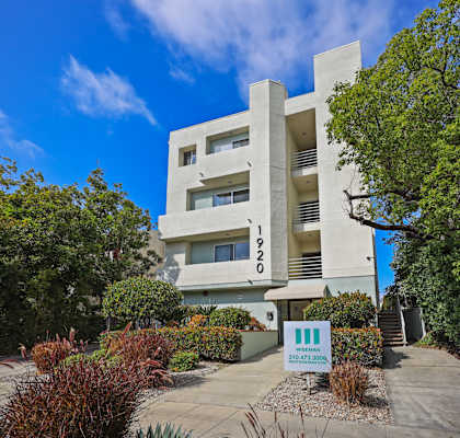 A modern building with a clear blue sky in the background.