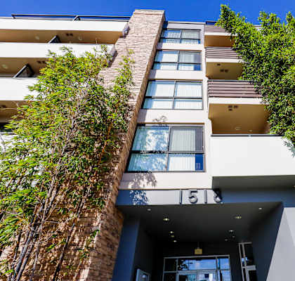 a photo of the front of a building with a green wall on the side of the building
