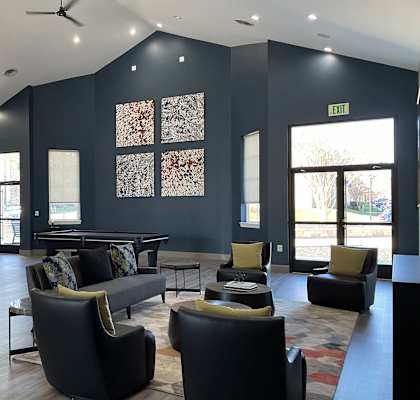 a resident clubhouse with a pool table and chairs at St. Charles at Olde Court Apartments, Pikesville, MD
