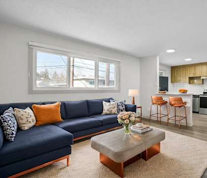 A blue sofa with a coffee table in front of it.