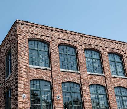a red brick building with a blue sky in the background