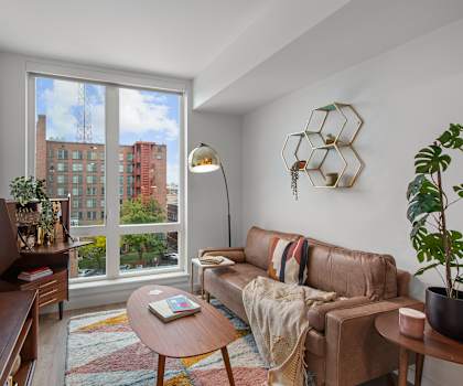 A living room with a brown couch and a flat screen TV.