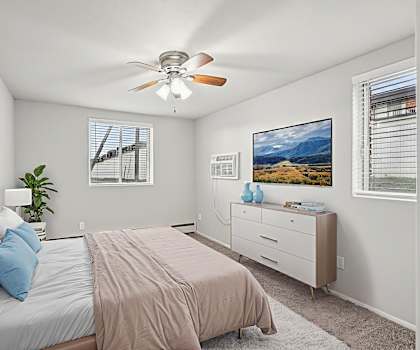 A bedroom with a bed, dresser, and two pictures on the wall.