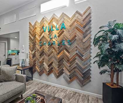 a living room with a couch and a wall with a quilt on it