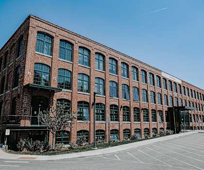 a large brick building with a parking lot in front of it