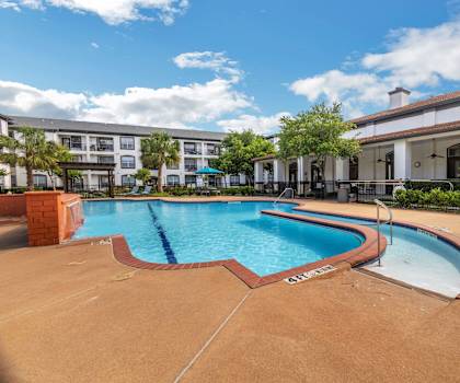 a swimming pool with a building in the background