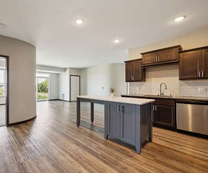 an open kitchen and living room with a large island in the middle