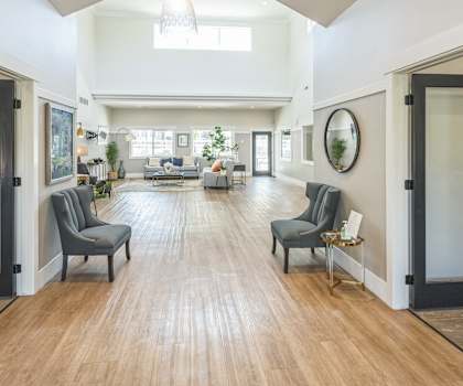 a large living room with a hard wood floor and doors