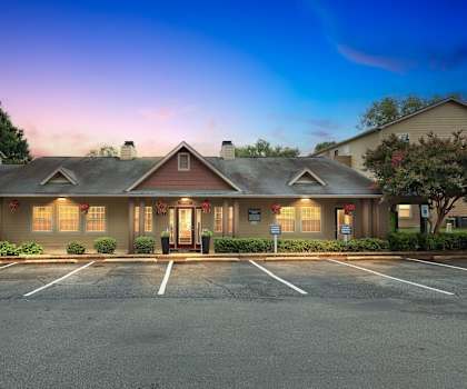 A building with a parking lot in front of it.
