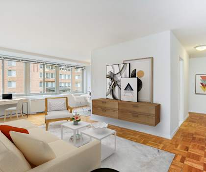 A living room with a couch, a coffee table, and a painting on the wall.