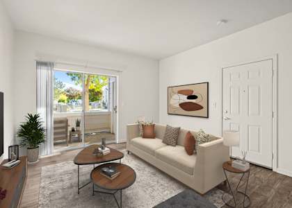 A living room with a couch, coffee table, and a painting on the wall.