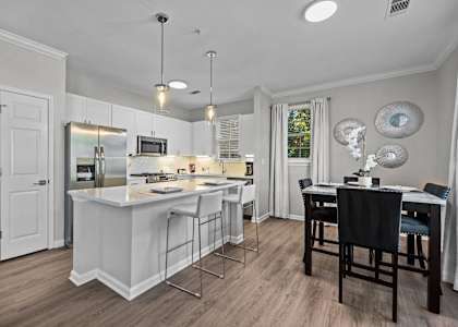 a kitchen with an island and a table with chairs