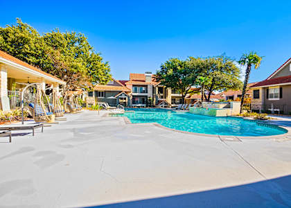 a swimming pool at a resort with trees